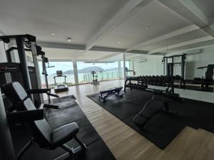 a gym with several treadmills and machines in a room at Langkawi Simfoni Luxury Suite 10 in Kuah