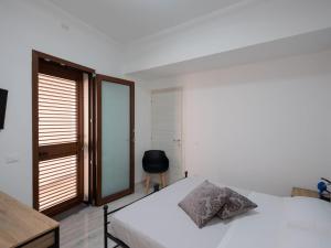Postel nebo postele na pokoji v ubytování Agorà di Favignana - Affittacamere Piazza Madrice