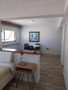 a bedroom with a bed and a desk in a room at Departamento 610 - Edificio VILAUT by INMOVE Temporarios in Córdoba +10 photos