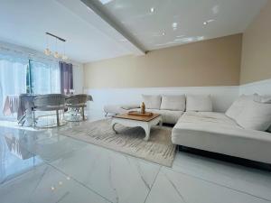 a living room with a white couch and a table at Casa Contemporaine in Angers