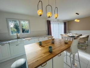 a kitchen with a wooden table and a dining room at Casa Contemporaine in Angers +23 photos