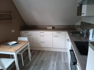 a small kitchen with a table and a sink at Appartement am Stadtrand von Minden in Minden +2 photos