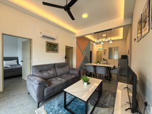 a living room with a couch and a table at Langkawi Simfoni Luxury Suite 11 in Kuah