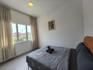 a bedroom with a teddy bear sitting on the bed at Langkawi Simfoni Luxury Suite 11 in Kuah +85 photos