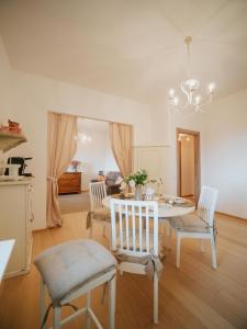 a dining room with a white table and chairs at dimora 13 in Casale Marittimo +40 photos