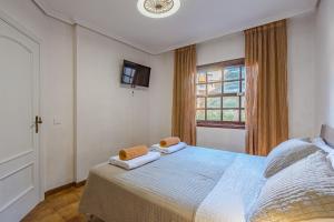 a bedroom with a bed with two towels on it at Sea View Albatros Golf del Sur in San Miguel de Abona +16 photos