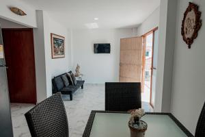 a living room with a table and chairs at Casa campestre en punta canoa Cartagena in Punta Canoas