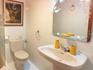 a bathroom with a sink and a toilet and a mirror at La Rectoral Arriondas 2 VV-2637-AS in Arriondas +42 photos