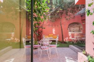 a patio with a table and chairs in front of a building at toctoctoc lisboa in Lisbon