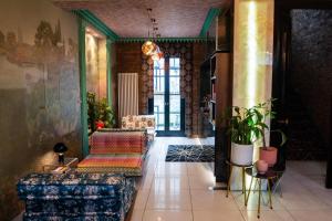 a lobby with couches and plants in a building at The Melville Hotel by Rokxy- Kings Cross in London
