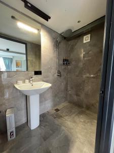 a bathroom with a sink and a shower at Green Therapy Cottage in Ranau +55 photos