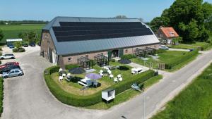 an overhead view of a building with solar panels on it at Hof Olmenstein in Goes