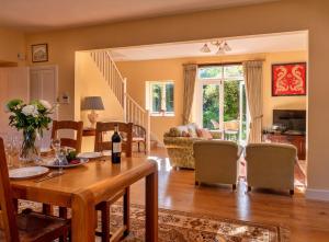 a living room with a table and a dining room at Finest Retreats - Lodge Cottage in Kingham