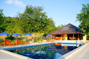 a resort with a swimming pool with chairs and umbrellas at Faasai Resort & Spa in Ban Nong Nam Khao