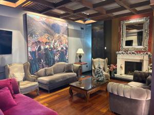 a living room with couches and a painting on the wall at Hotel Sancho Abarca Petit SPA in Huesca