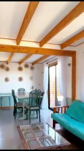 a living room with a table and chairs and a couch at Casa Chagre los molles Brisas del mar in Los Molles