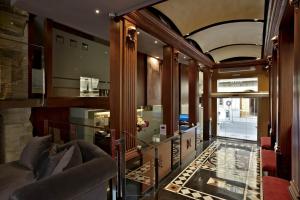 a living room with a couch and a glass floor at Hotel Sancho Abarca Petit SPA in Huesca