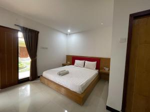 Ένα ή περισσότερα κρεβάτια σε δωμάτιο στο Melati Resort & Hotel Kuta Lombok