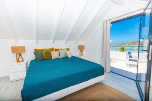 a bedroom with a bed with a view of the ocean at The views from the home were beautiful in Cul de Sac +45 photos