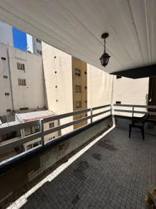 an empty balcony with a bench on a building at Departamento a 3 cuadras de la playa in Mar del Plata