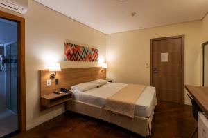 Postel nebo postele na pokoji v ubytování Hotel Amália