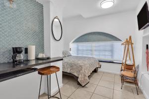 a bedroom with a bed and a desk and a window at Private Studio in Little Havana in Miami