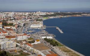 an aerial view of a city next to the water at Setubal Apartments in Setúbal