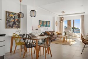 a dining room and living room with a table and chairs at Beautiful Family Apartment by Costarentals- Ref 24 in Sitio de Calahonda