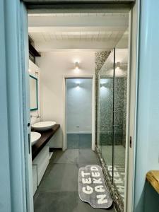 a bathroom with a glass shower and a sink at Industrial Loft - Garage-Netflix-wifi in Brescia +26 photos