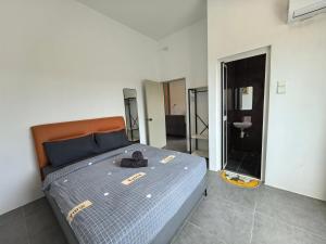 a bedroom with a bed with a pair of shoes on it at Langkawi Simfoni Luxury Suite 05 in Kuah +77 photos