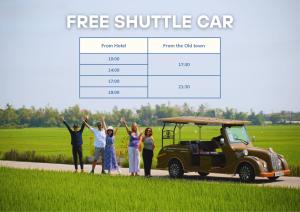 a group of people standing next to a golf cart at Athenia Hoi An Boutique Hotel & Spa in Hoi An