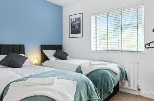 Ένα ή περισσότερα κρεβάτια σε δωμάτιο στο Spacious 3BR Nottingham City Hospital with PS4