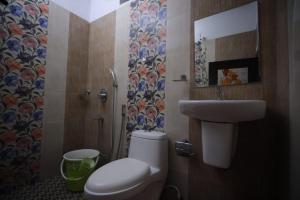 a bathroom with a toilet and a sink at Marari dhaniel beach homestay-2 in Mararikulam