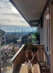 a balcony with potted plants on a building at Milan Top-Floor Flat City View 2 Balconies Workspace M5 in Milan