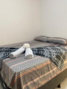 a bed with two towels on top of it at Brisa Bitingui in Japaratinga +4 photos