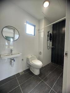 a bathroom with a toilet and a sink and a mirror at horizon ipoh in Ipoh