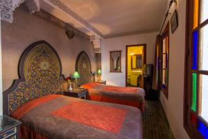 Postel nebo postele na pokoji v ubytování Riad - Dar Al Andalous