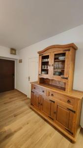 a large wooden cabinet in a room with wooden floors at House Casa in Sotillo de la Adrada in Sotillo de la Adrada