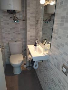 a bathroom with a toilet and a sink and a mirror at Xalana con terraza y magnificas vistas al mar in Girona +19 photos
