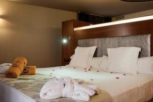 a hotel room with a bed with towels on it at Hotel Sancho Abarca Petit SPA in Huesca
