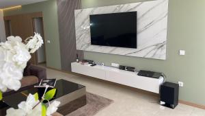 a living room with a flat screen tv on a wall at Condomínio Horizonte in Praia