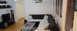 a living room with a couch and a coffee table at Apartman Aylin 2 in Tuzla