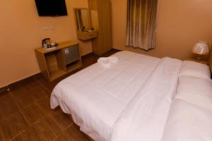 Voodi või voodid majutusasutuse Pyramids Express View Hotel toas