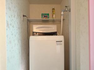 a white refrigerator with a shelf on top of it at 瀬戸内瓦町301 in Takamatsu