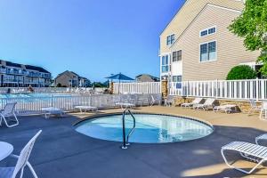 a swimming pool with chairs and a building at Bayville Shores --- 35729 Coleman Ave in Selbyville