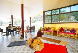 a person sitting at a table in a living room at Faasai Resort & Spa in Ban Nong Nam Khao