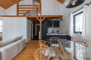 a living room with a couch and a table and chairs at Gorska Vila in Kopaonik