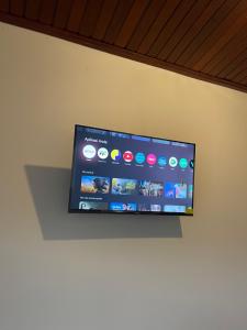 a flat screen tv hanging on a wall at Besakih villa in Besakih