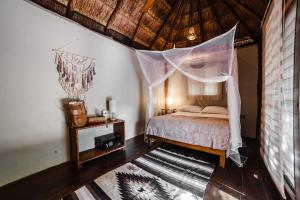 a bedroom with a bed with a mosquito net at Eco Bañitas Tulum in Tulum +93 photos