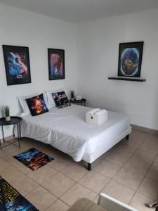 a bedroom with a white bed with a box on it at C301 Appartement Proche DisneyLand Paris in Montévrain